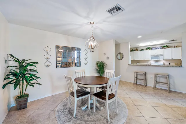 a dining room with furniture and a chandelier