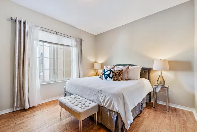 a bedroom with a bed and wooden floor