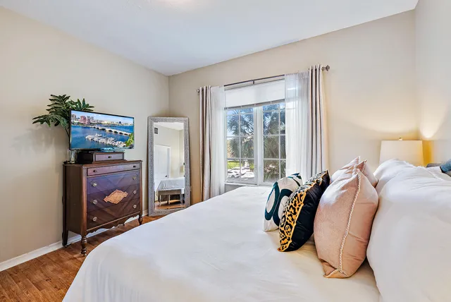 a bedroom with a bed and a painting on the wall