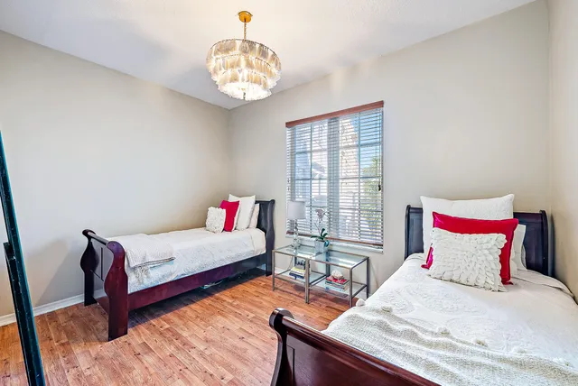 a bedroom with a bed and a chandelier