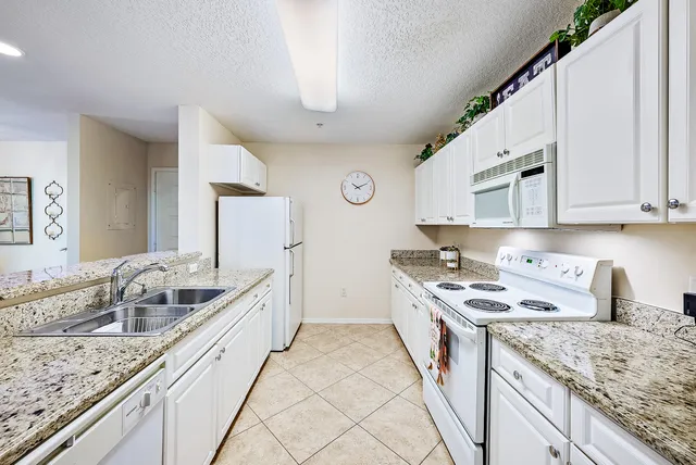 a kitchen that has a sink and a stove