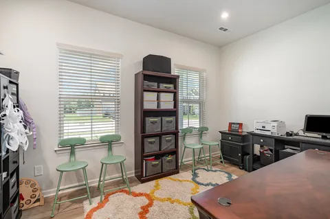 a workspace with furniture bookshelf and a window