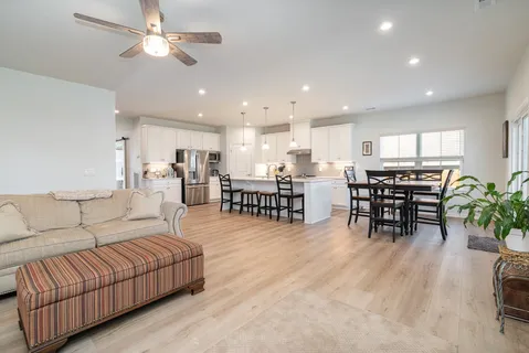 a living room with furniture and kitchen view