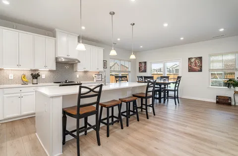 a view of a dining area with furniture and wooden floor