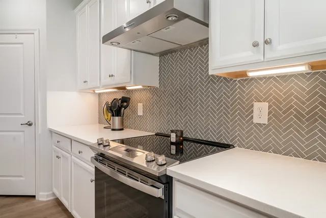 a kitchen with a stove and a refrigerator