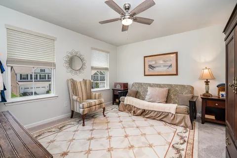 a living room with furniture a window and a chandelier