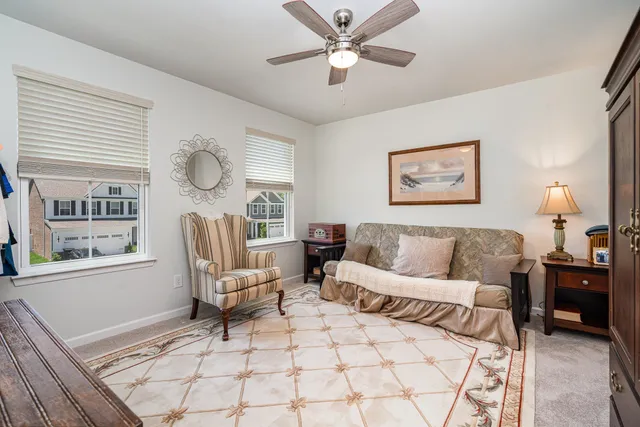 a living room with furniture a window and a chandelier