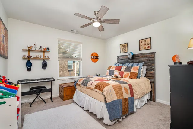 a bedroom with bed and a chandelier