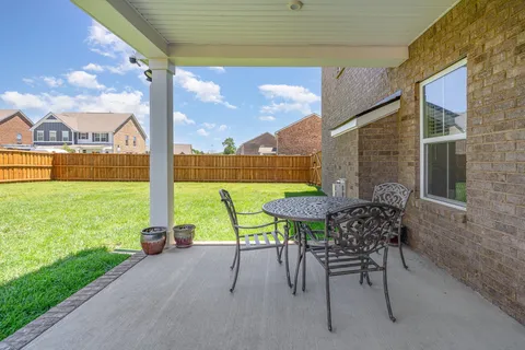 a view of a patio with a table chairs and a table