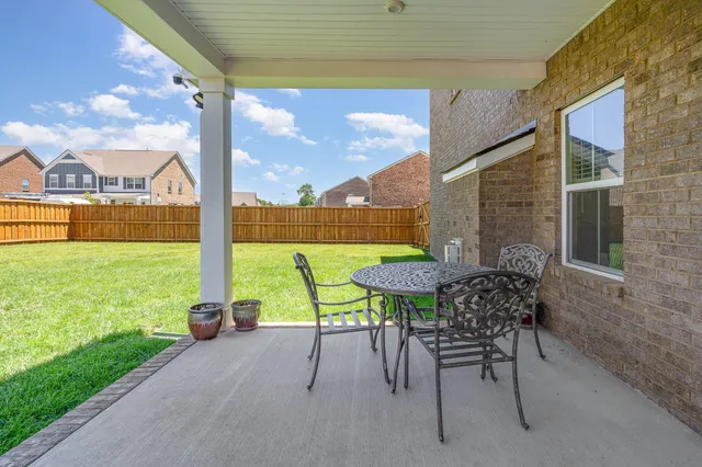 a view of a patio with a table chairs and a table