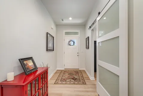 a view of room with furniture and wooden floor