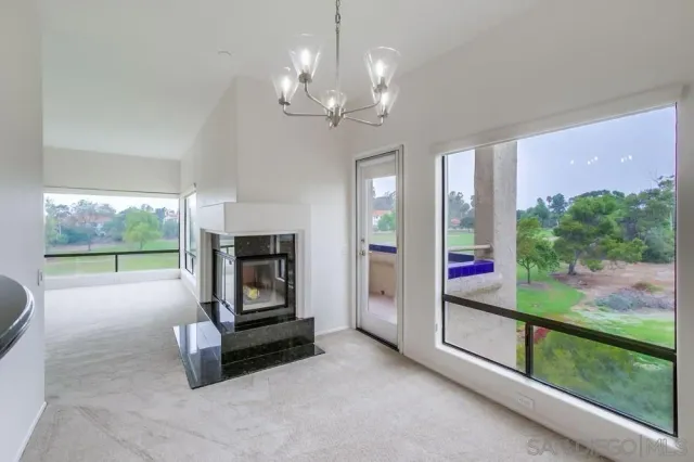 a living room with furniture and a floor to ceiling window
