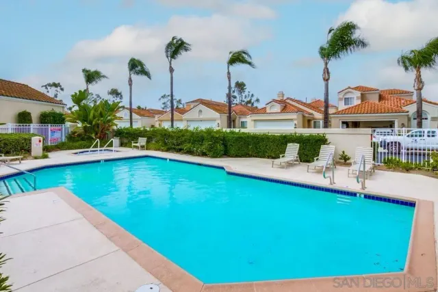a view of a house with pool and a garden