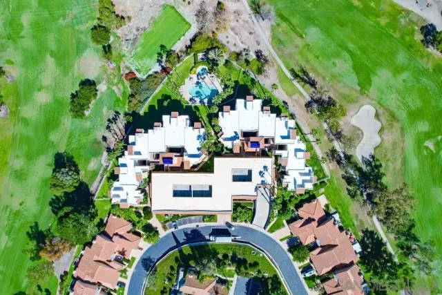 a front view of a house with a yard and garden