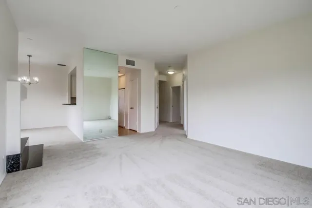 a kitchen with granite countertop a sink a stove and cabinets