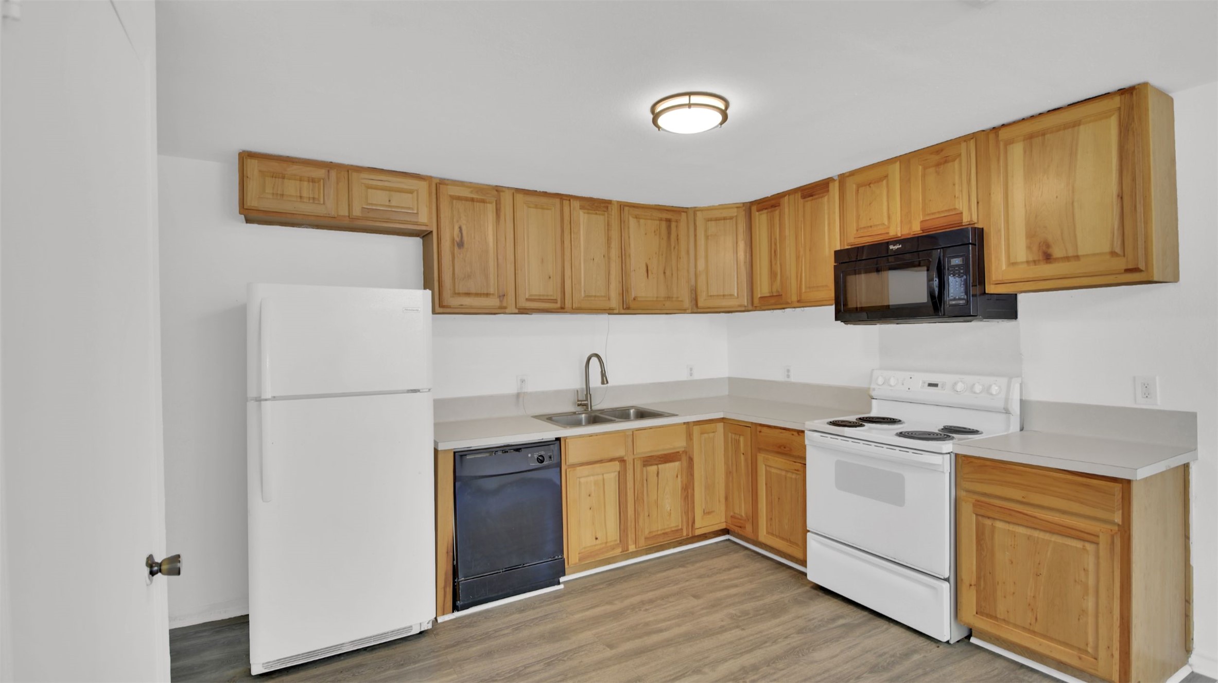 908 Tank Street Lockhart, TX 78644 - Photo 10 of 22 a kitchen with a sink a stove and cabinets