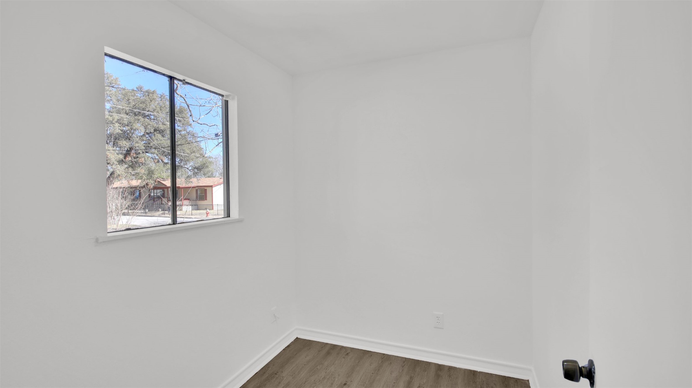 908 Tank Street Lockhart, TX 78644 - Photo 17 of 22 an empty room with windows