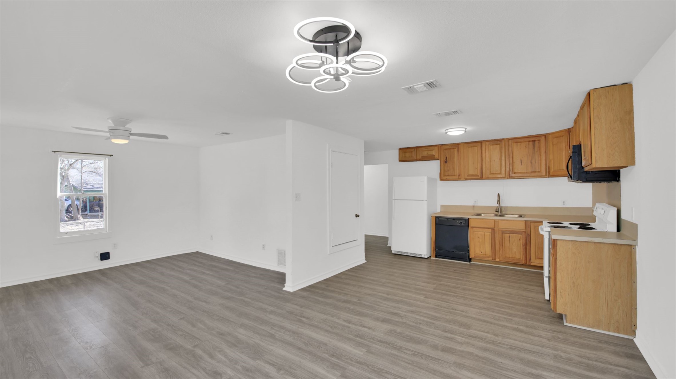 908 Tank Street Lockhart, TX 78644 - Photo 22 of 22 a kitchen with a refrigerator and a stove top oven