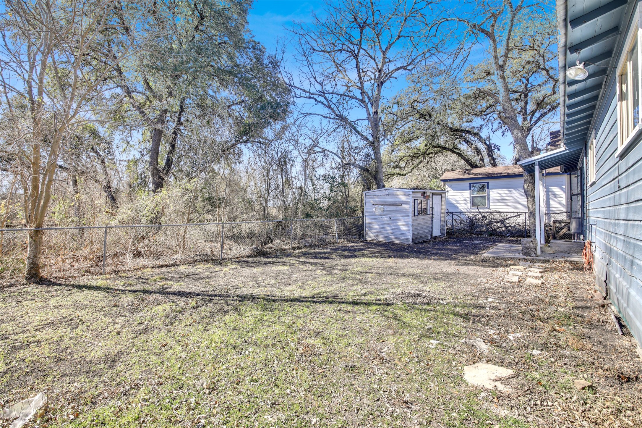 908 Tank Street Lockhart, TX 78644 - Photo 21 of 22 a view of a yard with a large tree