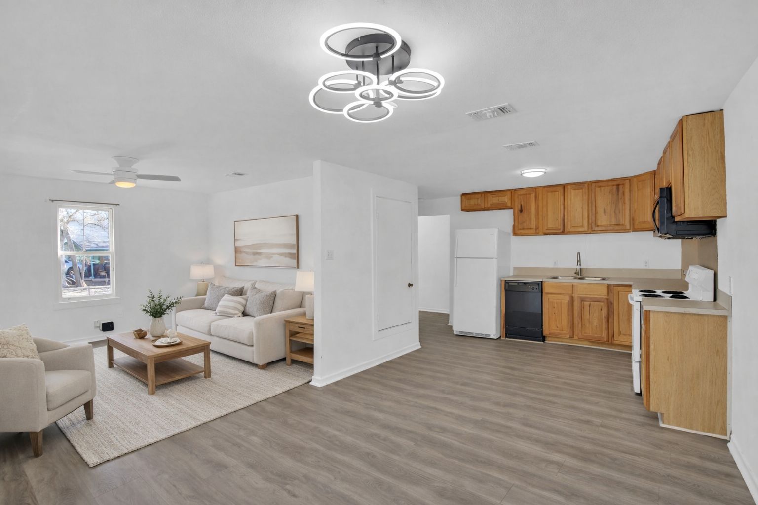 908 Tank Street Lockhart, TX 78644 - Photo 2 of 22 a living room with stainless steel appliances kitchen island a table and a couch