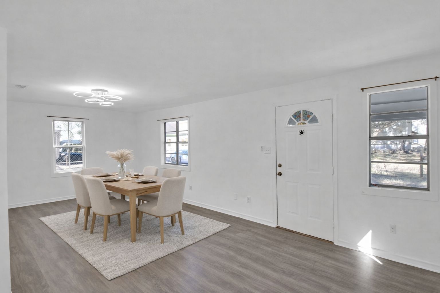 908 Tank Street Lockhart, TX 78644 - Photo 4 of 22 a dining room with wooden floor and white walls