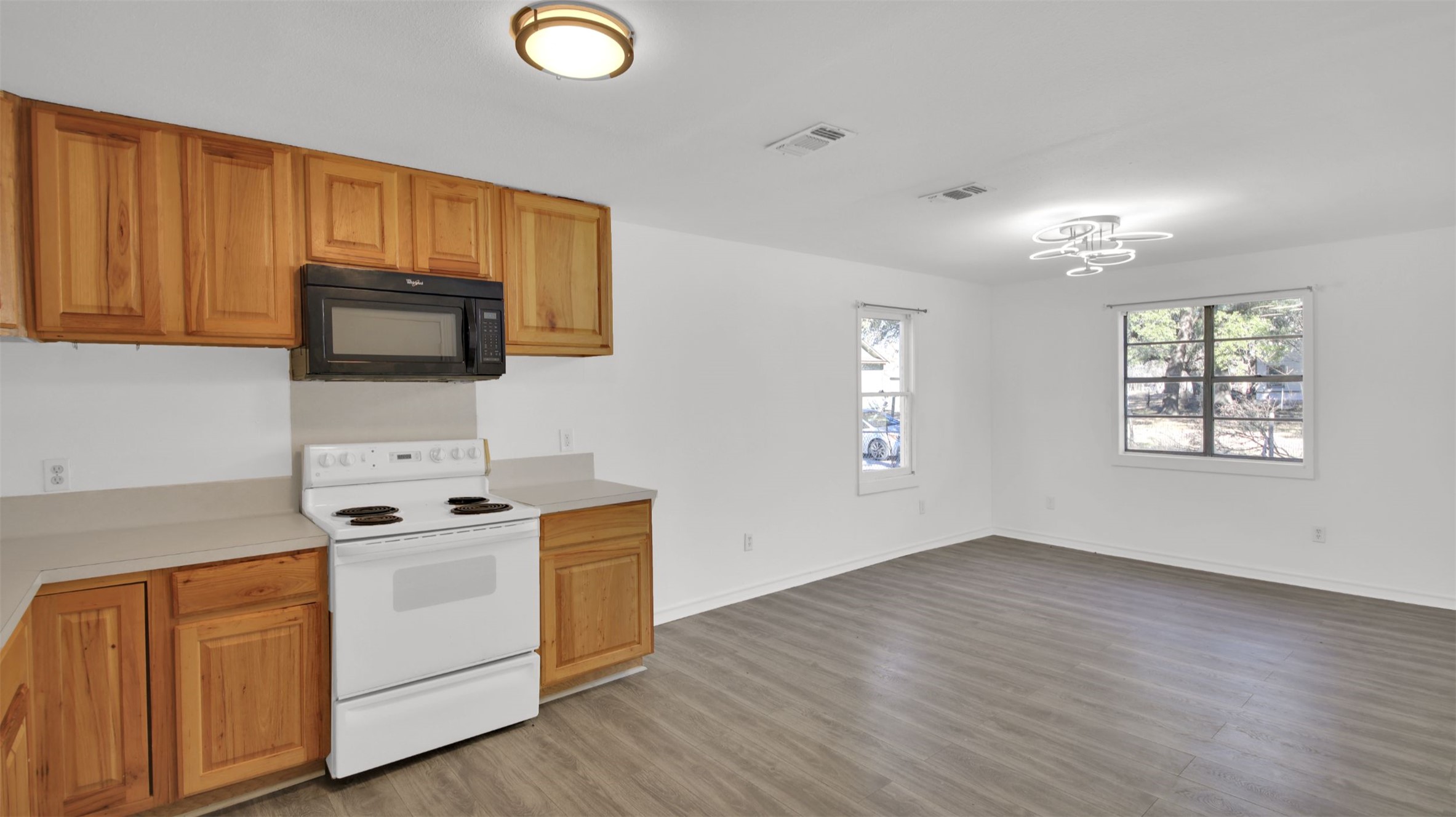 908 Tank Street Lockhart, TX 78644 - Photo 8 of 22 a view of kitchen with wooden floor and electronic appliances