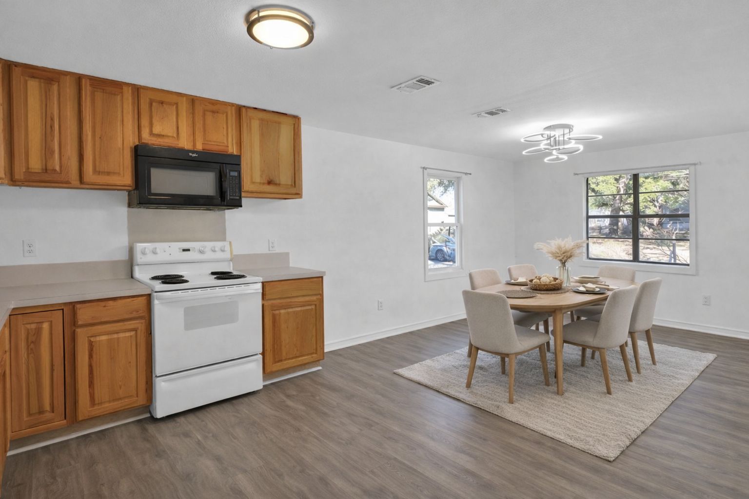 908 Tank Street Lockhart, TX 78644 - Photo 9 of 22 a view of a dining room with furniture and wooden floor