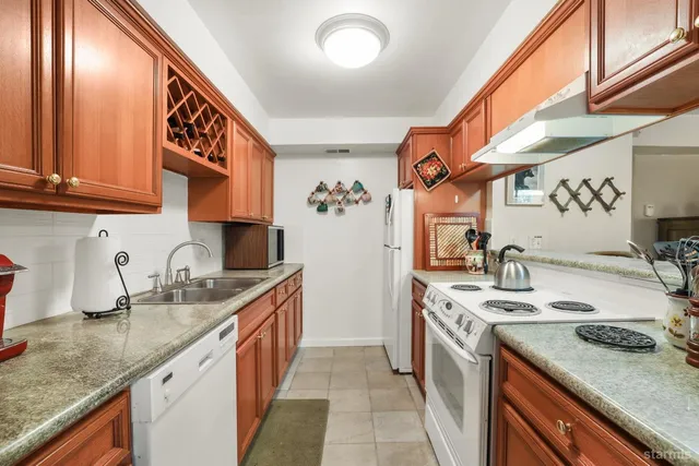 a kitchen with a sink stove and cabinets