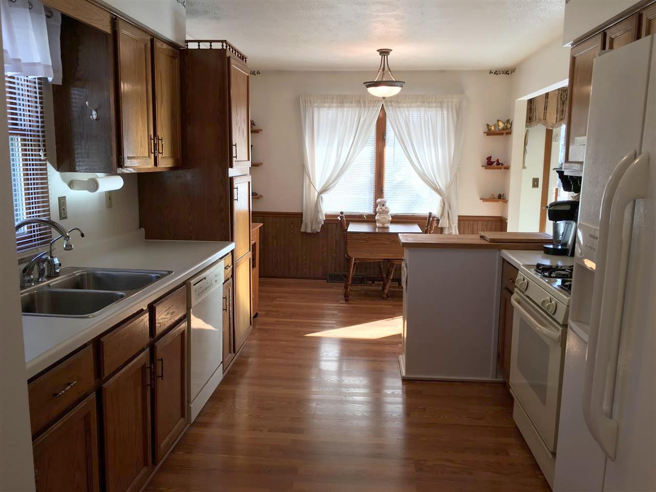 3289 North Trainer Road Rockford, IL 61114 - Photo 4 of 19 a kitchen with stainless steel appliances a sink cabinets and wooden floor
