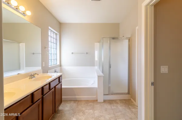 a bathroom with a tub sink and mirror