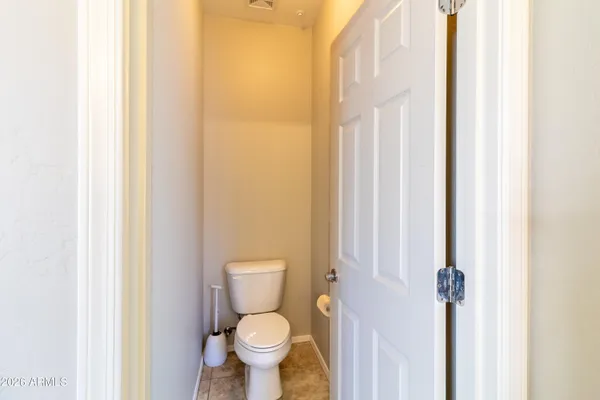 a white toilet sitting next to a shower