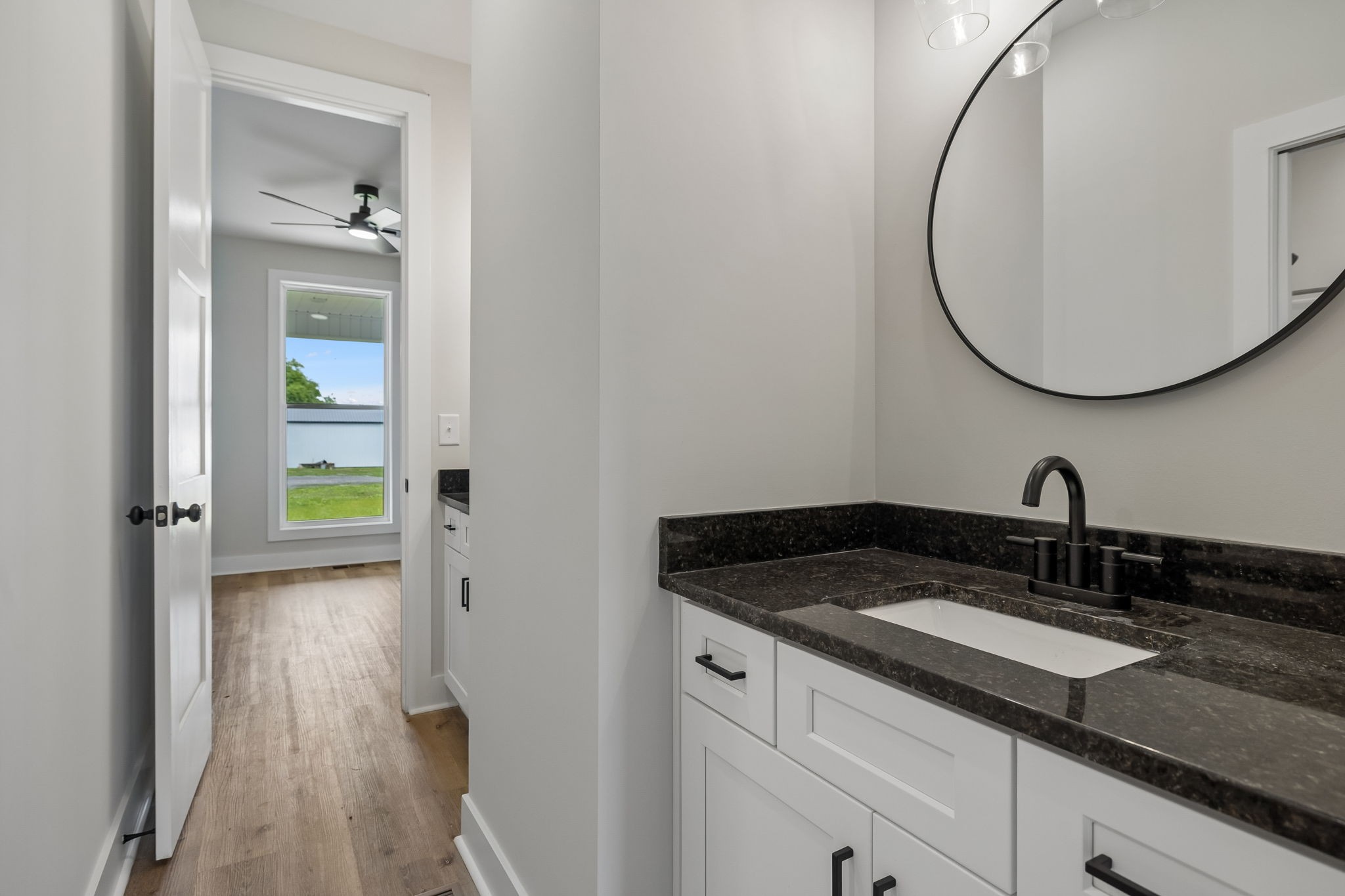 777 Rock Springs Road Castalian Springs, TN 37031 - Photo 29 of 52 a en suite bathroom with a granite countertop sink and a mirror