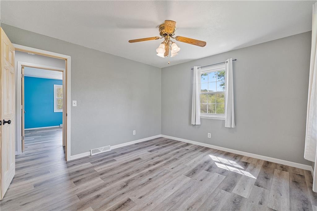 351 Pleasant Valley Road Washington, PA 15301 - Photo 22 of 41 a view of an empty room with a window and wooden floor