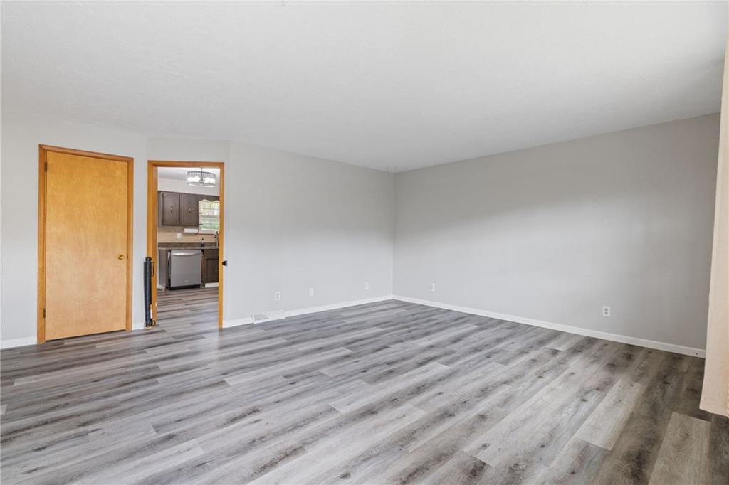 351 Pleasant Valley Road Washington, PA 15301 - Photo 4 of 41 a view of an empty room with wooden floor and a window