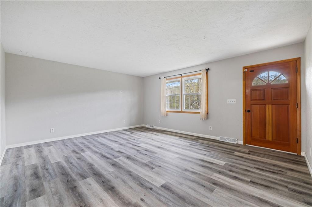 351 Pleasant Valley Road Washington, PA 15301 - Photo 5 of 41 an empty room with wooden floor and windows