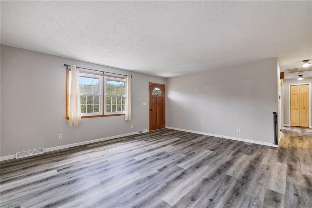 351 Pleasant Valley Road Washington, PA 15301 - Photo 6 of 41 an empty room with wooden floor and windows
