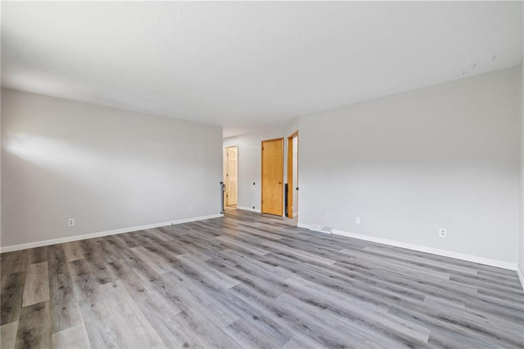 351 Pleasant Valley Road Washington, PA 15301 - Photo 7 of 41 a view of an empty room with wooden floor and window