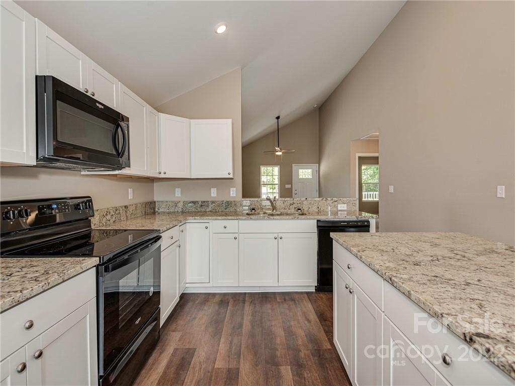 1324 Long Branch Road, Unit 2 Grover, NC 28073 - Photo 3 of 24 a kitchen with granite countertop a sink dishwasher stove and microwave with wooden floor