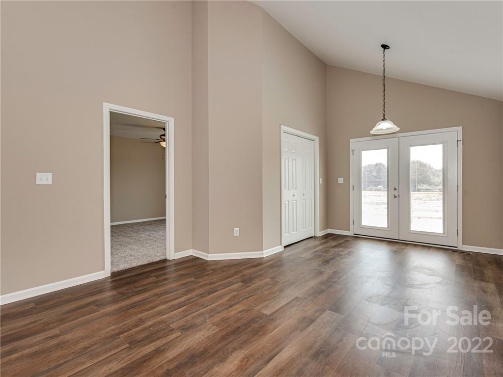 1324 Long Branch Road, Unit 2 Grover, NC 28073 - Photo 5 of 24 a view of an empty room with wooden floor and a window