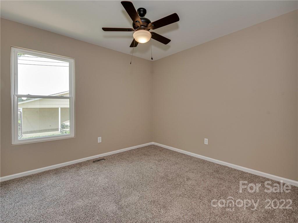 1324 Long Branch Road, Unit 2 Grover, NC 28073 - Photo 9 of 24 an empty room with a window and a ceiling fan