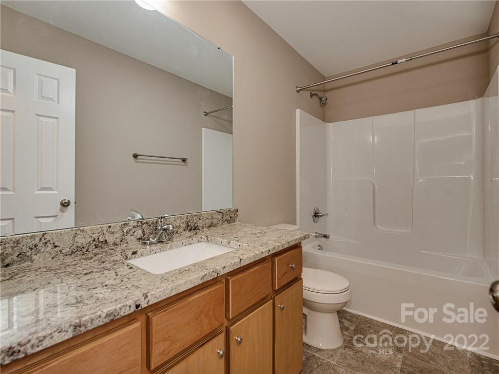 1324 Long Branch Road, Unit 2 Grover, NC 28073 - Photo 10 of 24 a bathroom with a granite countertop sink a toilet and shower