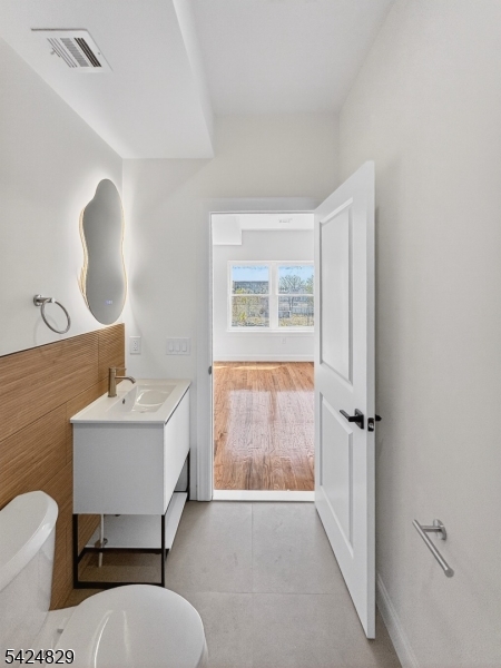 262 Hunterdon Street, Unit 1 Newark, NJ 07103 - Photo 23 of 31 a bathroom with a sink toilet a mirror and shower