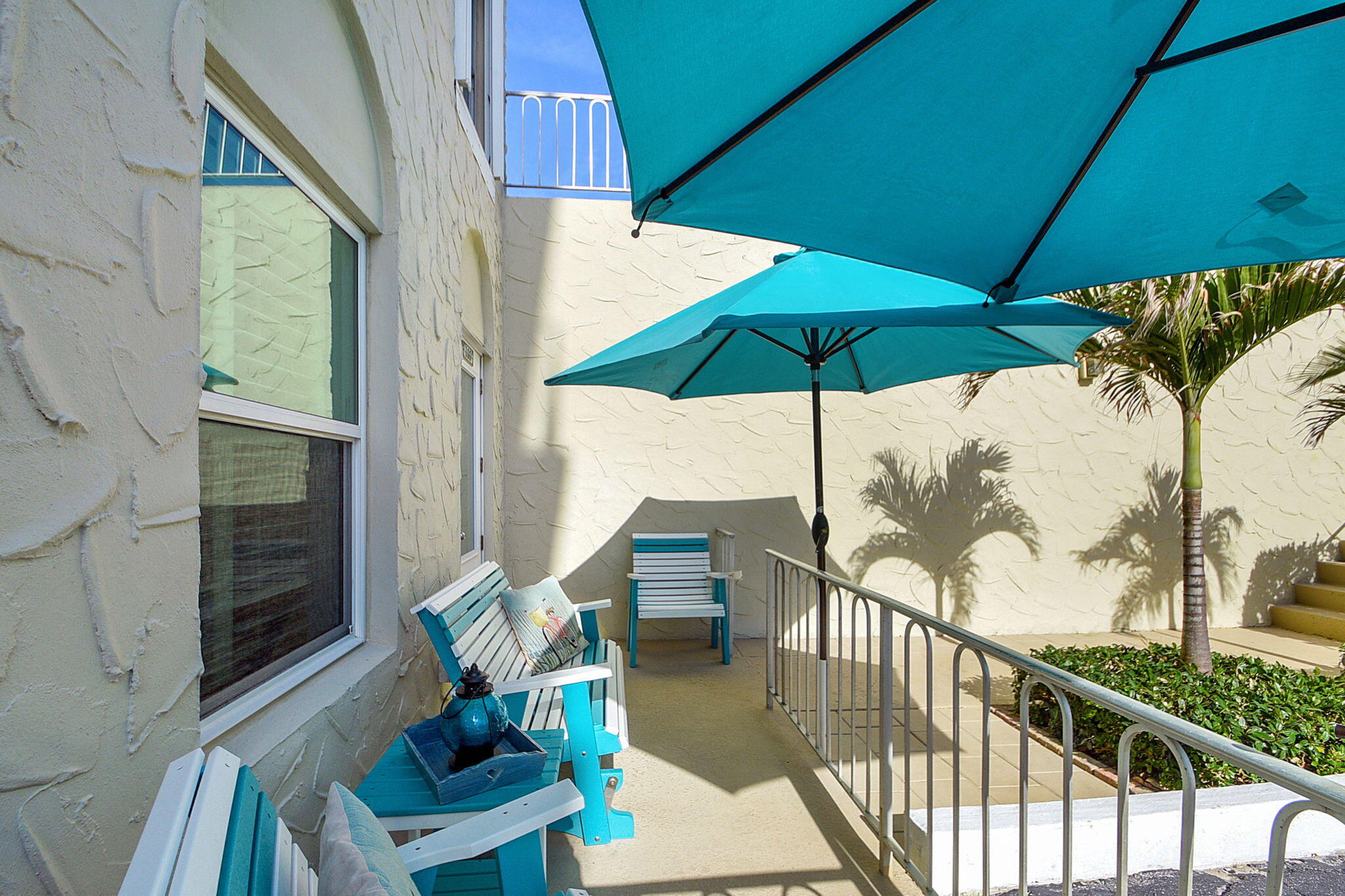 3230 South Ocean Boulevard, Unit C100 Palm Beach, FL 33480 - Photo 11 of 49 a view of balcony with furniture and umbrella
