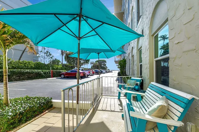 a view of balcony with furniture and umbrella