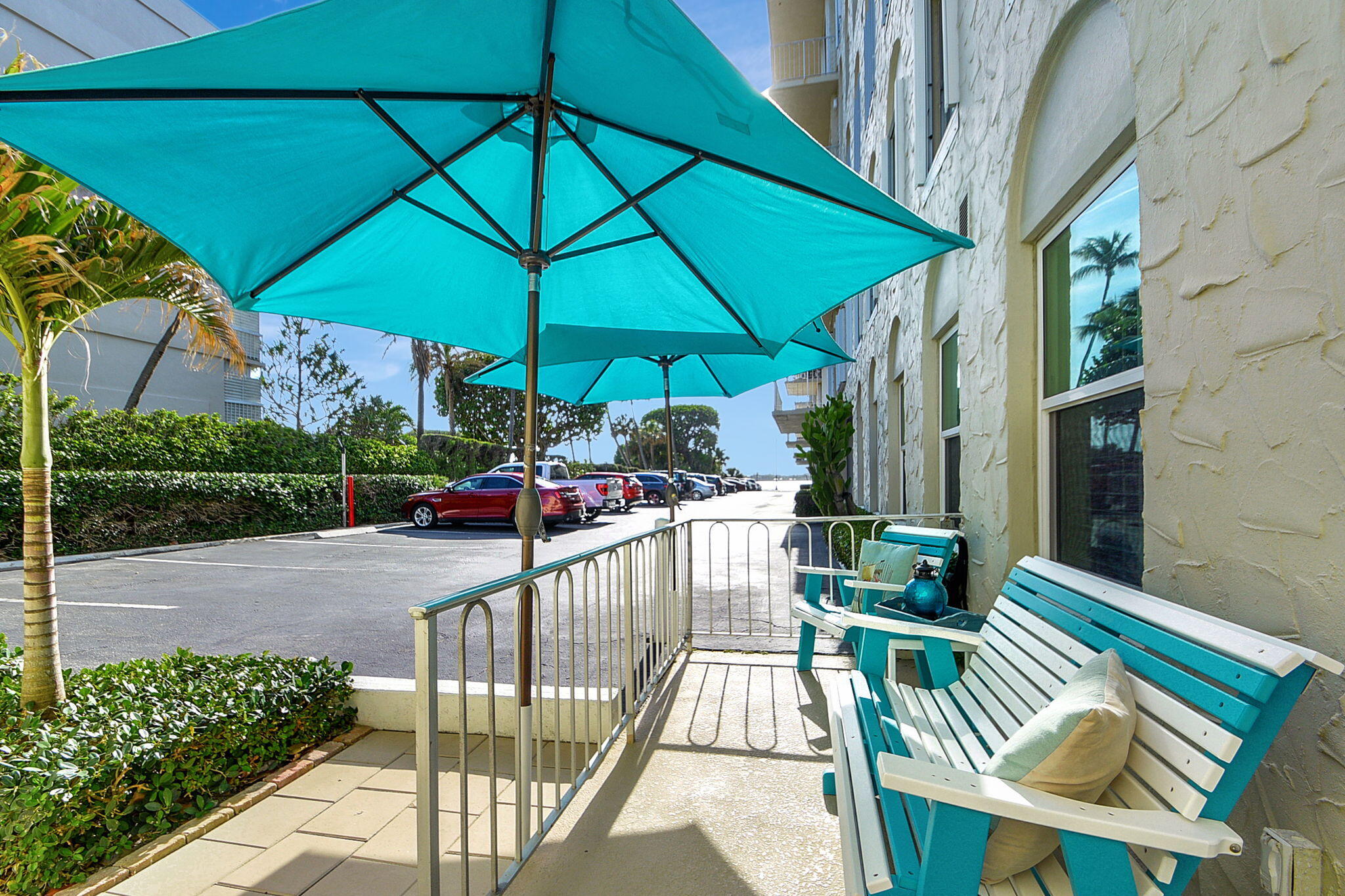 3230 South Ocean Boulevard, Unit C100 Palm Beach, FL 33480 - Photo 12 of 49 a view of a chair and tables in the patio