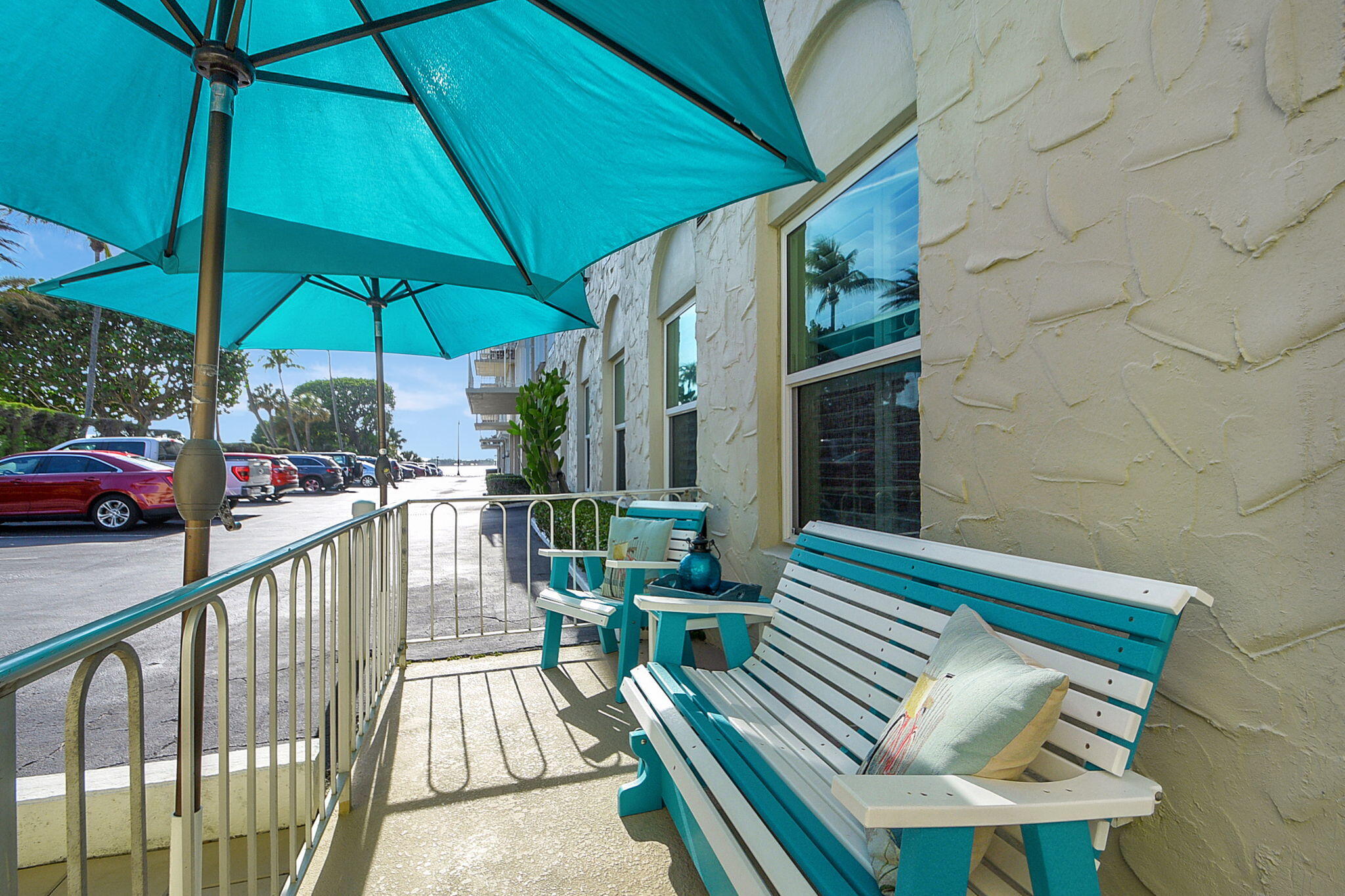 3230 South Ocean Boulevard, Unit C100 Palm Beach, FL 33480 - Photo 13 of 49 a view of balcony with furniture and umbrella