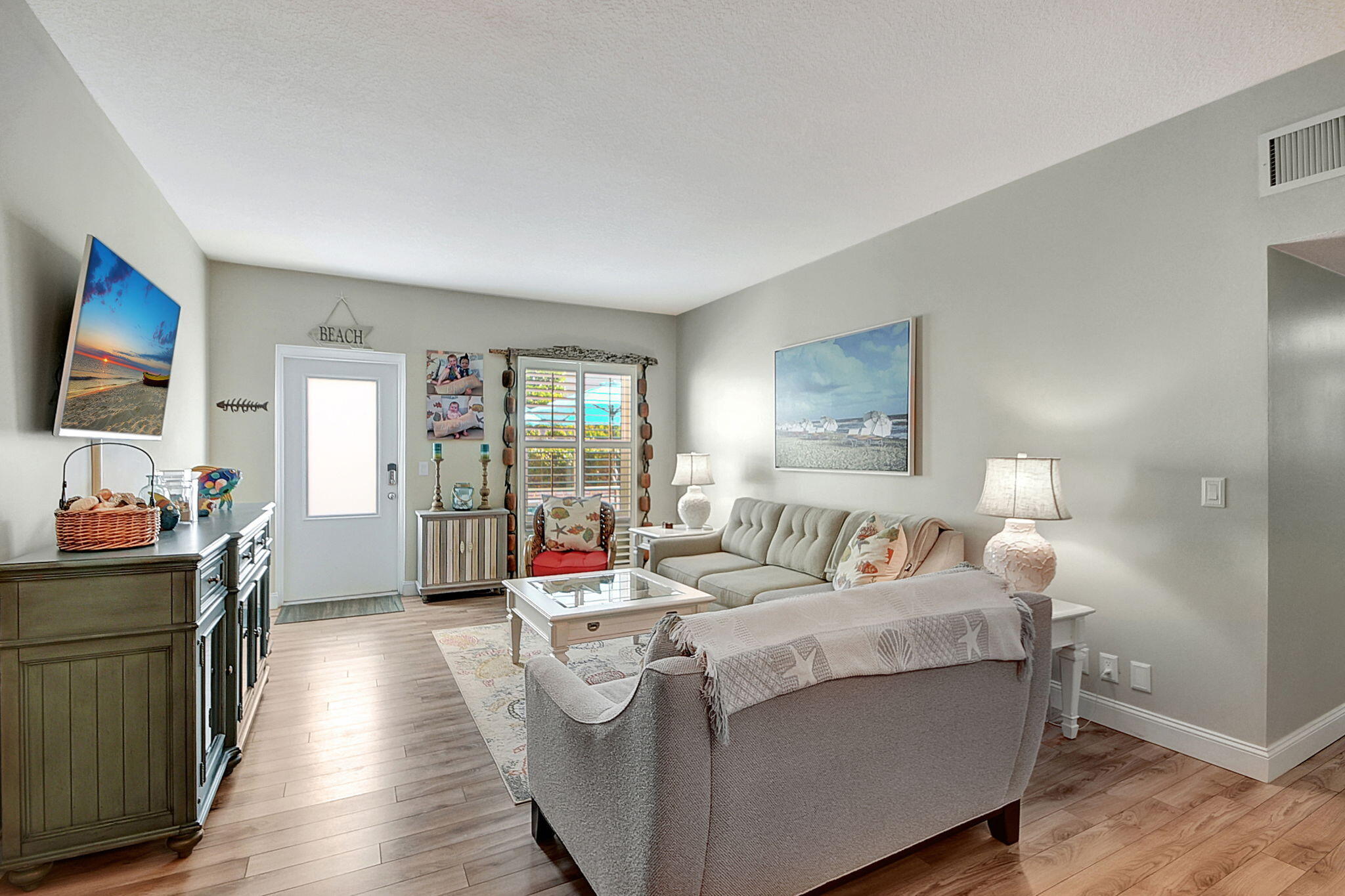 3230 South Ocean Boulevard, Unit C100 Palm Beach, FL 33480 - Photo 17 of 49 a living room with furniture and a flat screen tv