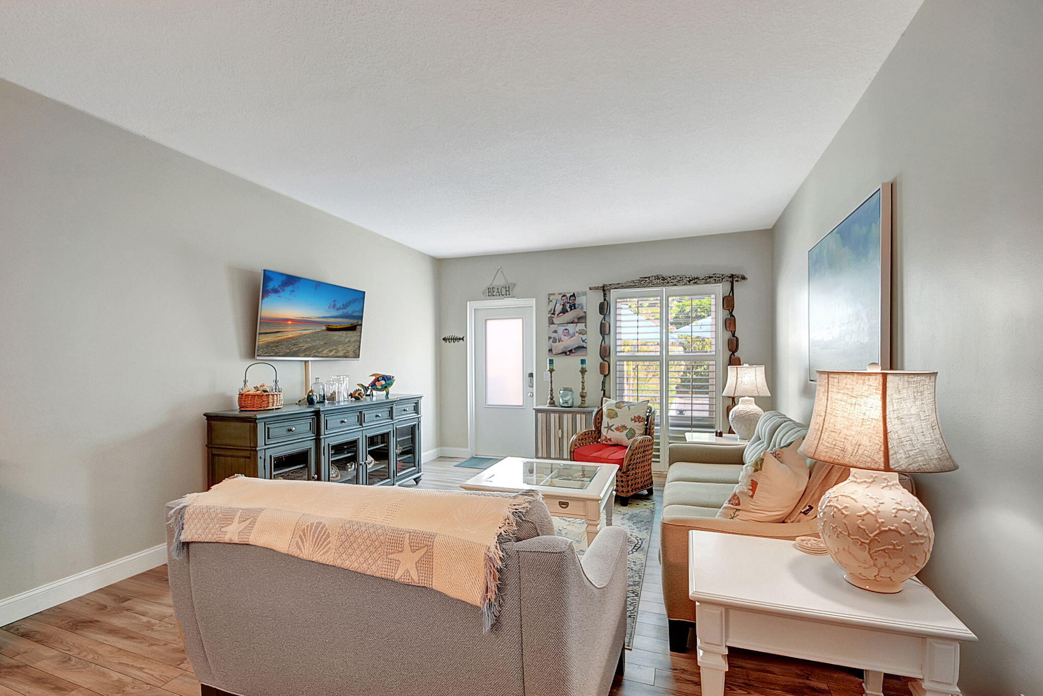 3230 South Ocean Boulevard, Unit C100 Palm Beach, FL 33480 - Photo 18 of 49 a living room with furniture and a flat screen tv