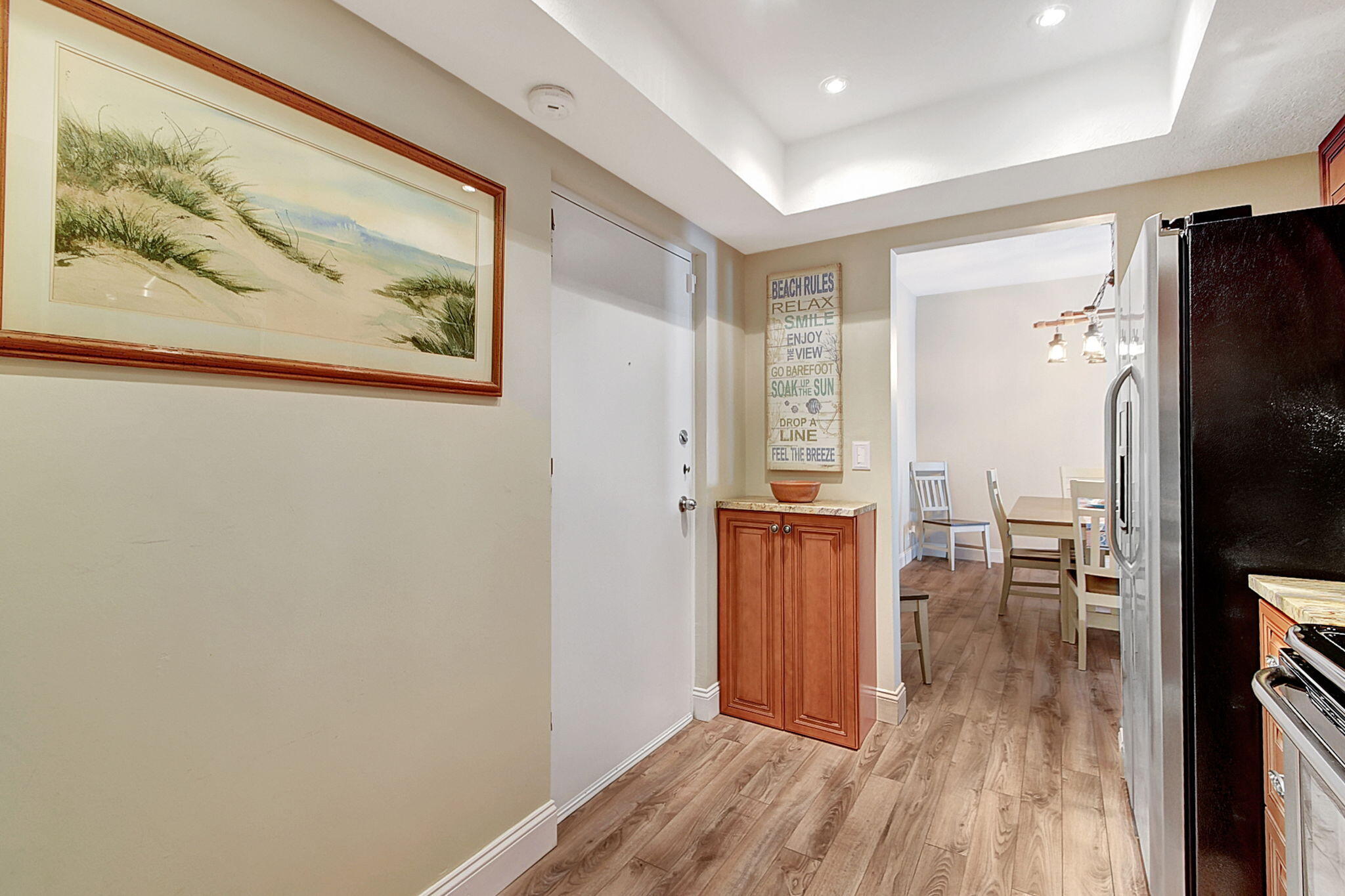 3230 South Ocean Boulevard, Unit C100 Palm Beach, FL 33480 - Photo 24 of 49 a view of a hallway with wooden floor and a living room