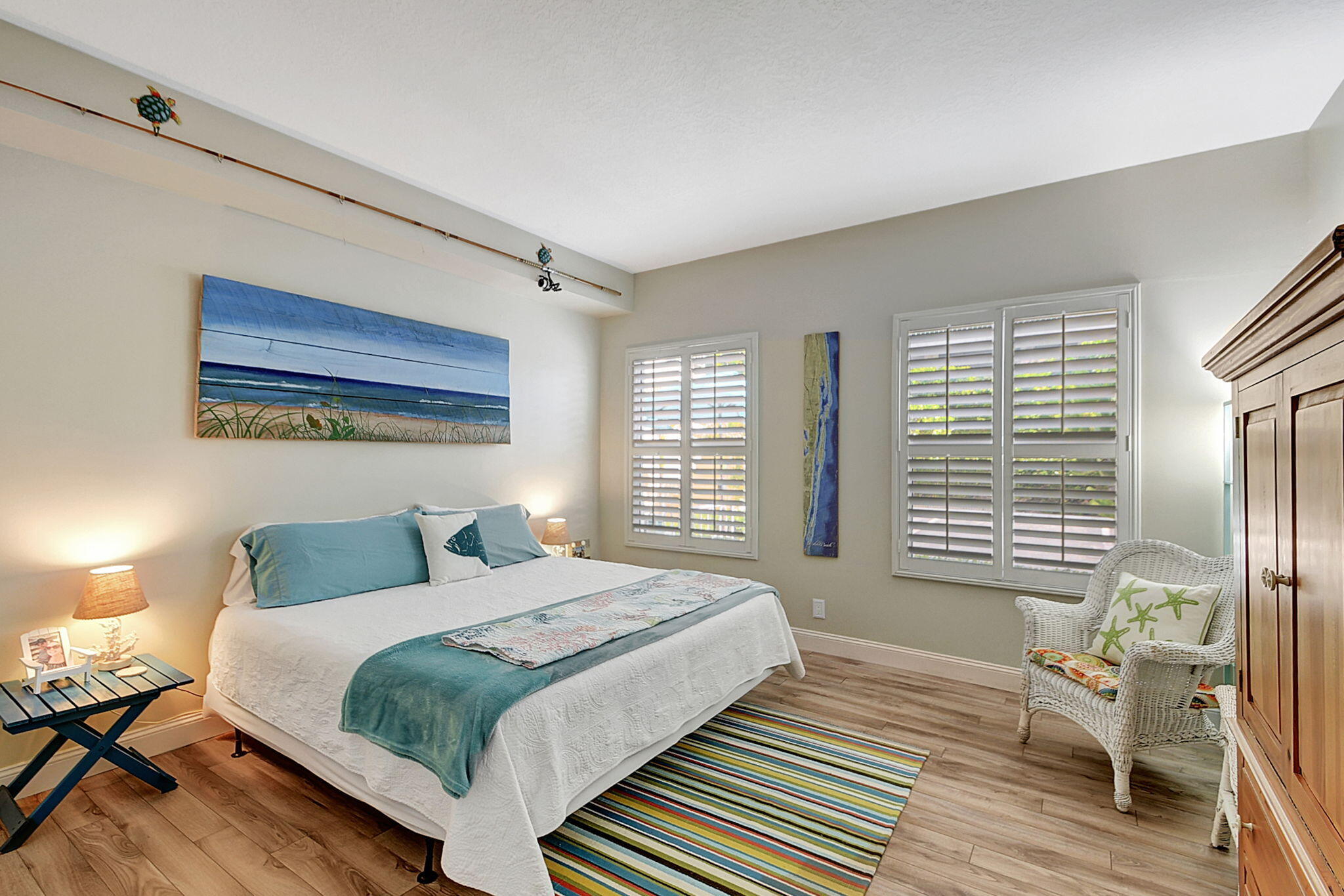 3230 South Ocean Boulevard, Unit C100 Palm Beach, FL 33480 - Photo 25 of 49 a bedroom with a bed and wooden floor